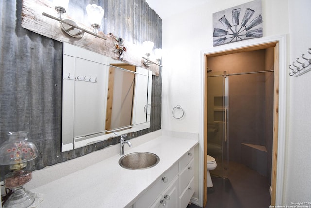 full bath featuring a stall shower, vanity, and toilet