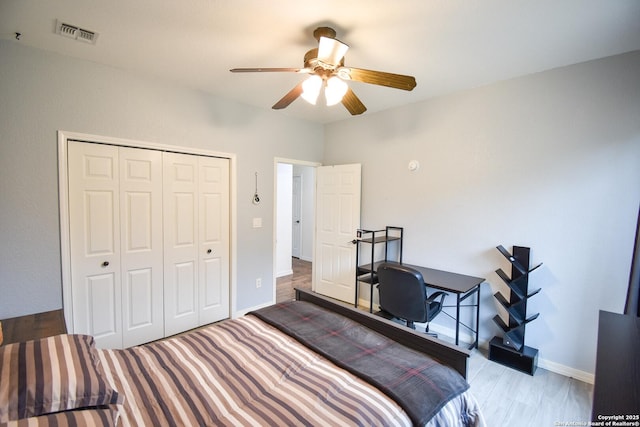 bedroom with a ceiling fan, a closet, visible vents, and baseboards