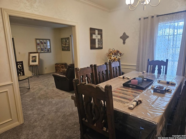 carpeted dining space with a notable chandelier, baseboard heating, and crown molding