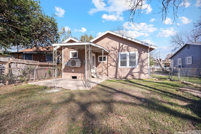 back of house with a fenced backyard, a yard, and a patio