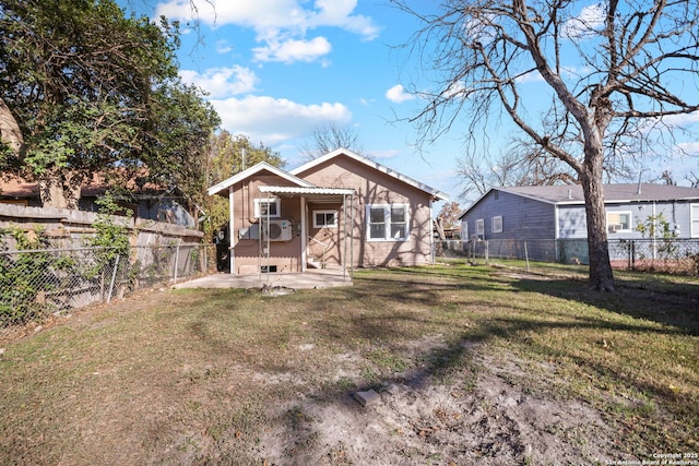 back of property featuring a patio area, a fenced backyard, and a lawn