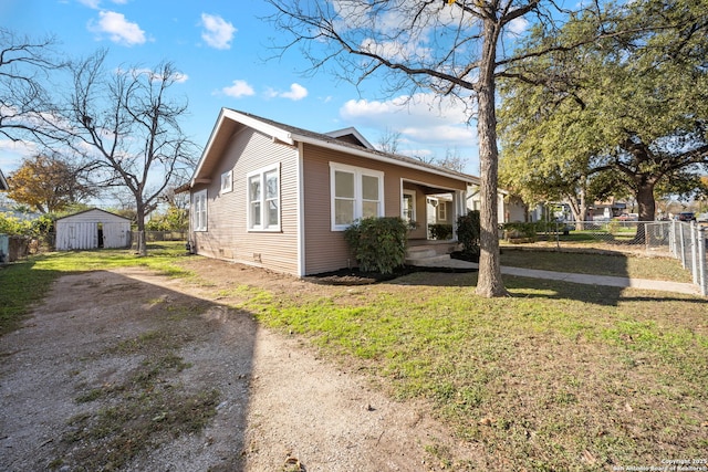 view of home's exterior with a lawn and fence