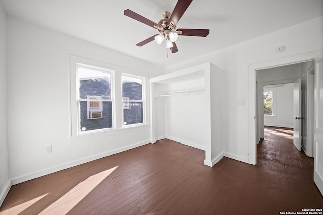 unfurnished room featuring ceiling fan, dark wood finished floors, and baseboards