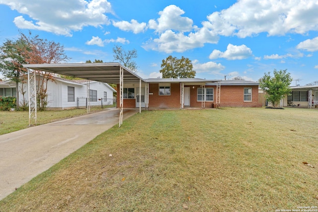 ranch-style home with concrete driveway, brick siding, a front yard, and an attached carport