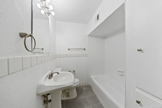 full bathroom with tile patterned flooring, visible vents, and toilet