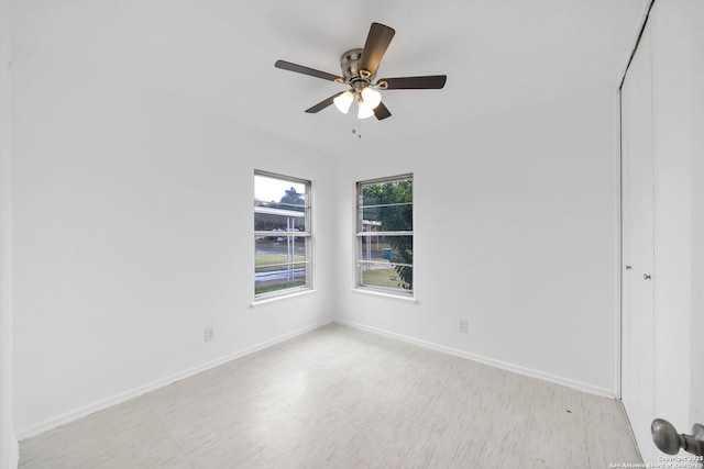 interior space featuring a ceiling fan and baseboards