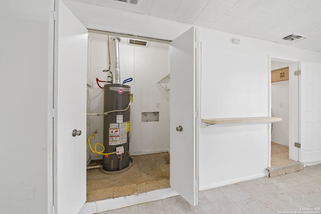 utility room with visible vents and gas water heater