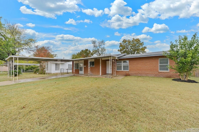 ranch-style home with a carport, concrete driveway, brick siding, and a front lawn