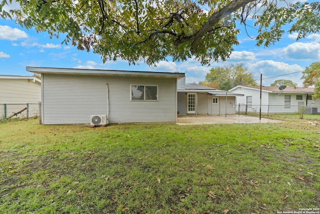 rear view of house featuring fence, a lawn, and a patio