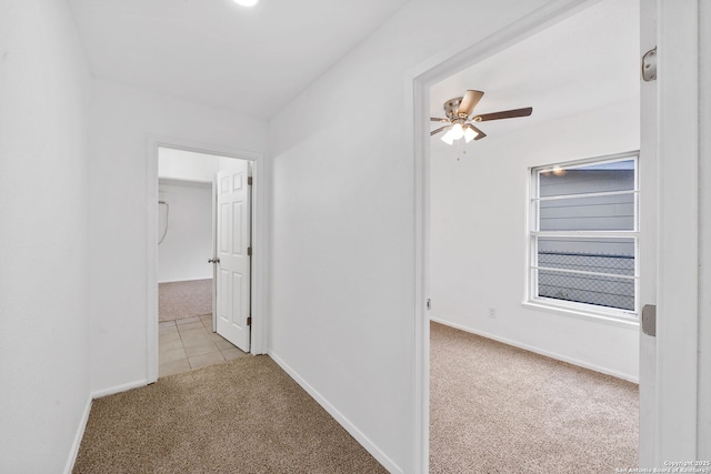 corridor with light carpet and baseboards