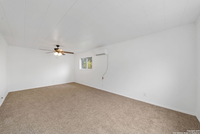 spare room with a wall unit AC, crown molding, carpet floors, and a ceiling fan