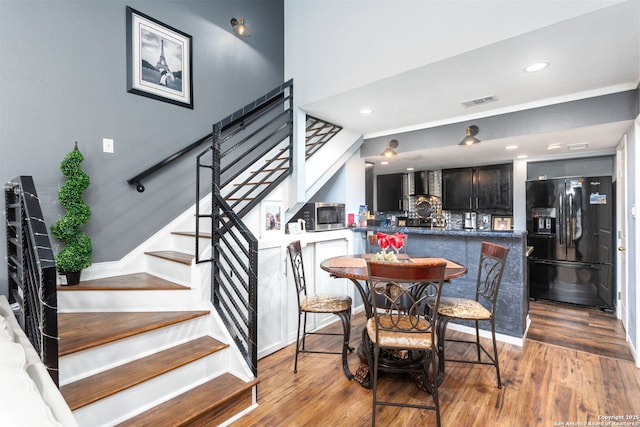 dining area featuring light wood-style flooring, stairs, visible vents, and recessed lighting