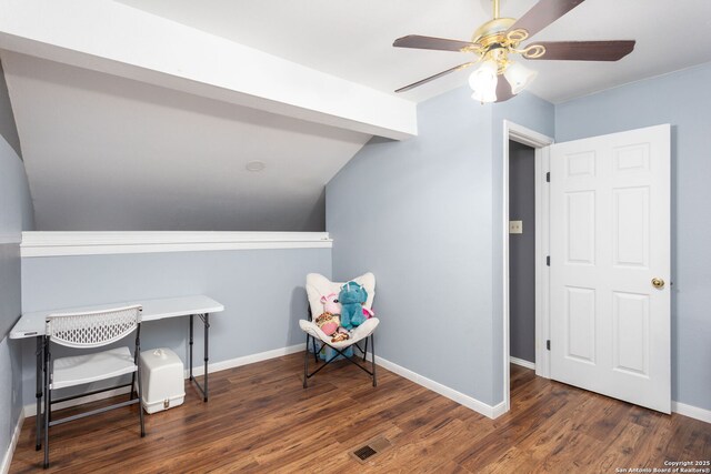 interior space featuring dark wood-style floors, vaulted ceiling, a ceiling fan, and baseboards