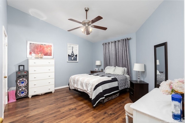 bedroom featuring dark wood-style floors, vaulted ceiling, and a ceiling fan