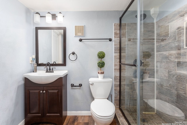 full bath with visible vents, toilet, wood finished floors, vanity, and a shower stall