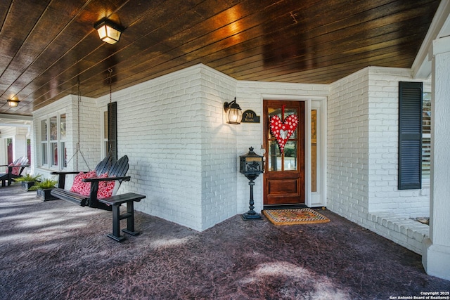 doorway to property with brick siding