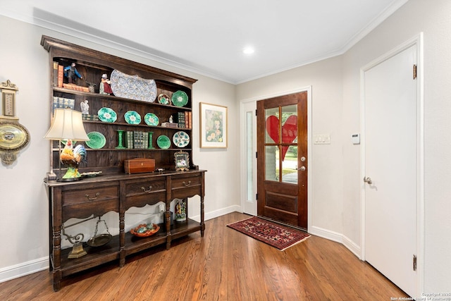 entrance foyer with baseboards, ornamental molding, wood finished floors, and recessed lighting