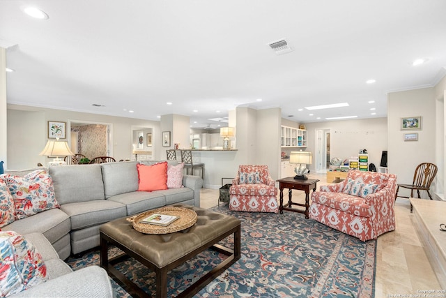 living area featuring baseboards, visible vents, crown molding, and recessed lighting