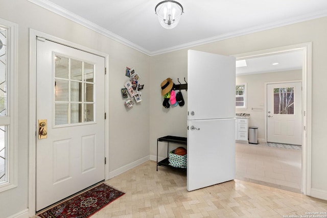 foyer featuring ornamental molding and baseboards