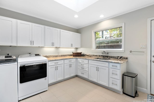 laundry room featuring cabinet space, ornamental molding, separate washer and dryer, a sink, and recessed lighting