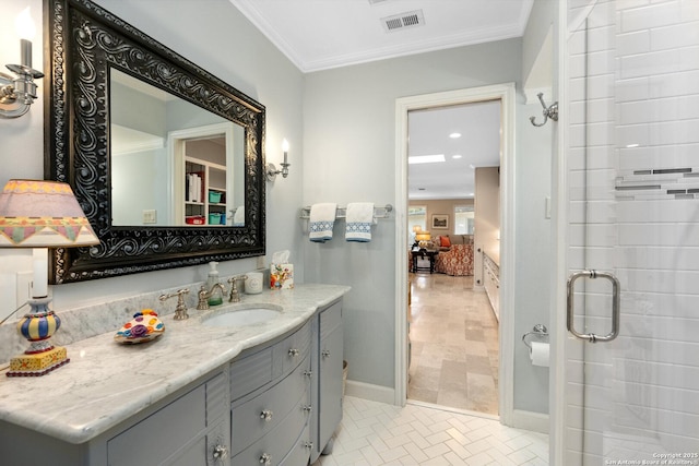 ensuite bathroom featuring crown molding, visible vents, connected bathroom, and vanity