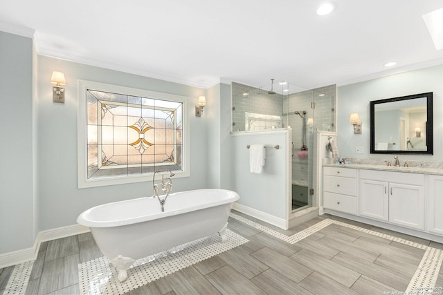 bathroom featuring baseboards, a soaking tub, crown molding, vanity, and a shower stall