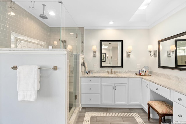 full bath featuring tile patterned floors, a shower stall, ornamental molding, and vanity