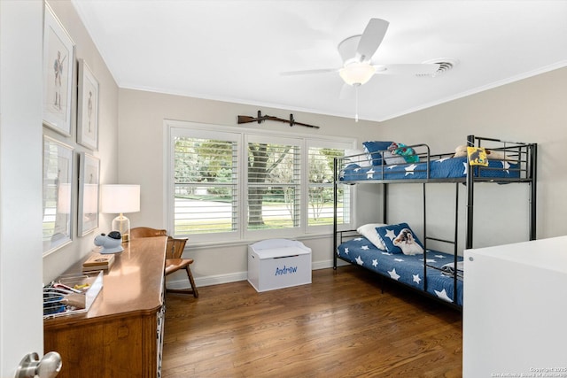 bedroom featuring dark wood-style floors, ornamental molding, baseboards, and a ceiling fan