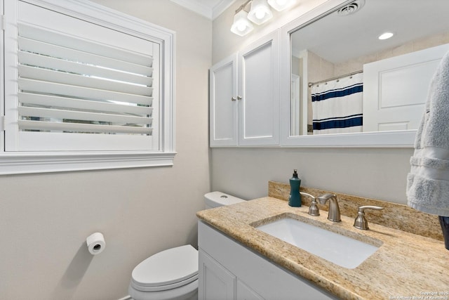 full bath with toilet, visible vents, crown molding, and vanity