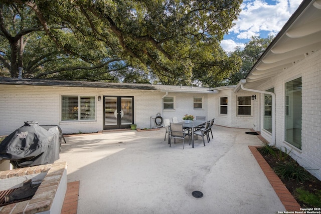 view of patio featuring french doors, outdoor dining space, and area for grilling