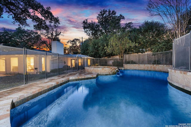 view of swimming pool featuring a fenced in pool, a fenced backyard, and an in ground hot tub