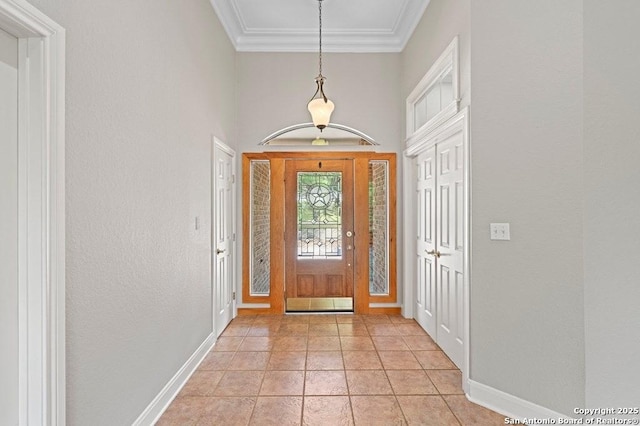 entryway featuring ornamental molding, baseboards, and light tile patterned floors