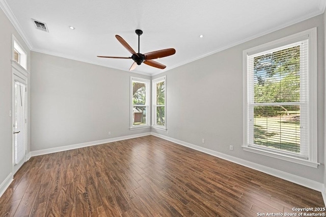 spare room featuring ornamental molding, dark wood finished floors, visible vents, and baseboards