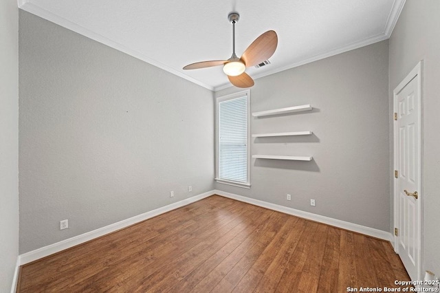 unfurnished room featuring ornamental molding, visible vents, baseboards, and wood finished floors