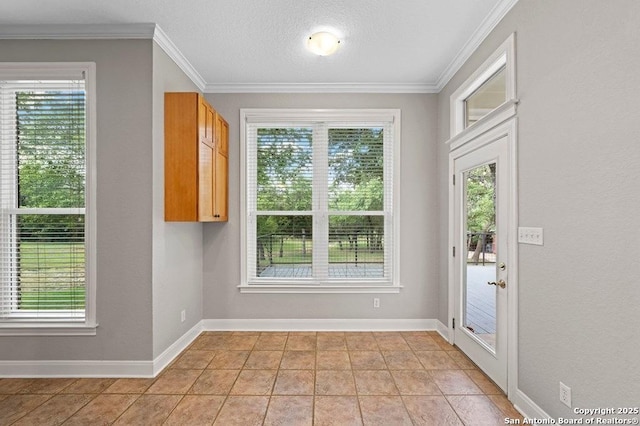 doorway featuring a healthy amount of sunlight, baseboards, and crown molding