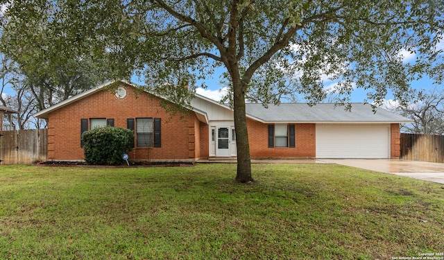 ranch-style house featuring a garage, a front yard, fence, and driveway