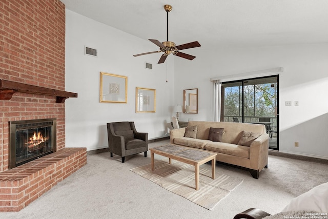 living area with high vaulted ceiling, light colored carpet, visible vents, and a fireplace