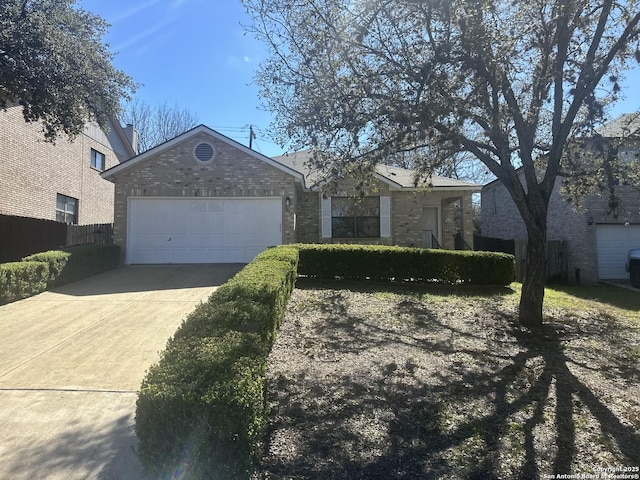 ranch-style house featuring a garage, driveway, brick siding, and fence