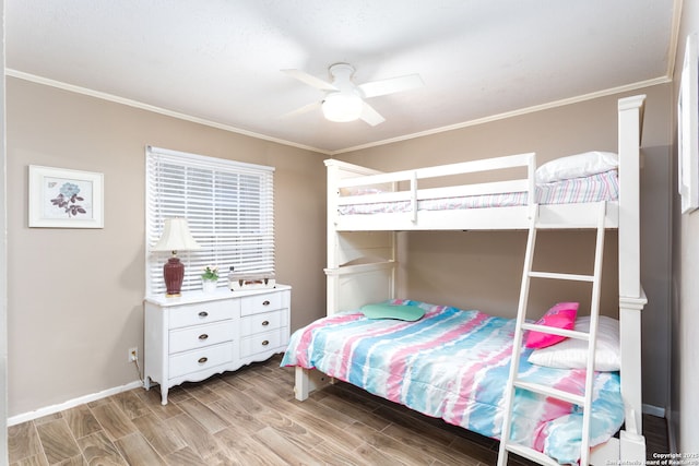 bedroom featuring light wood-type flooring, crown molding, and ceiling fan