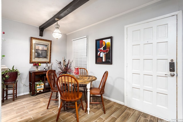 dining room featuring crown molding, wood tiled floor, beamed ceiling, and baseboards