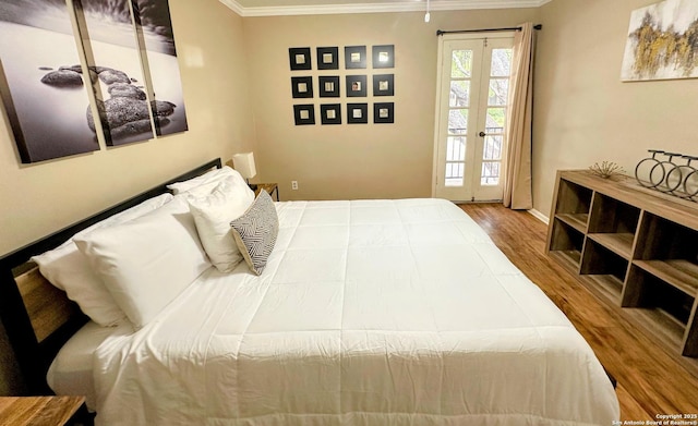 bedroom featuring baseboards, access to outside, wood finished floors, and crown molding