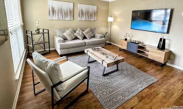 living area featuring dark wood-type flooring and baseboards