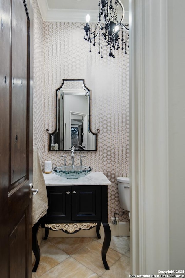 bathroom with toilet, ornamental molding, vanity, tile patterned flooring, and wallpapered walls