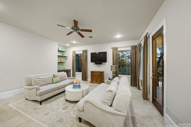 living room with baseboards, a ceiling fan, and recessed lighting