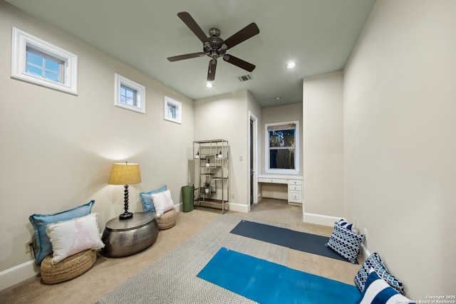 exercise room featuring light carpet, baseboards, visible vents, built in desk, and recessed lighting