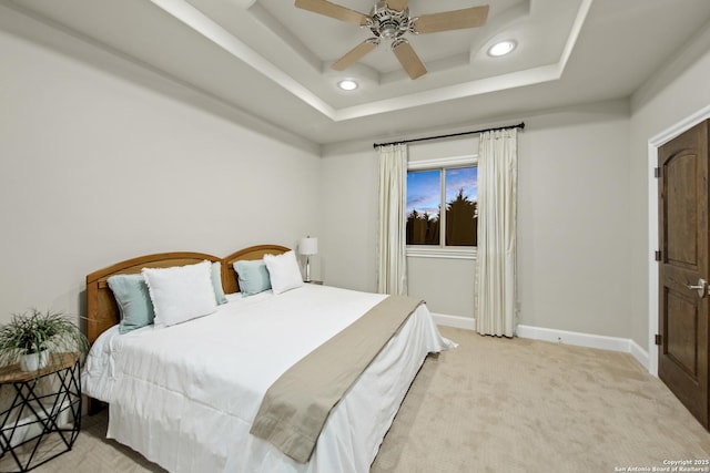 bedroom with light carpet, baseboards, a raised ceiling, ceiling fan, and recessed lighting