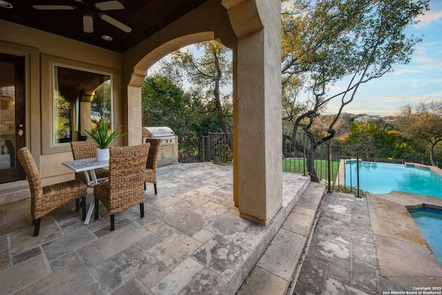 view of patio / terrace featuring outdoor dining area, fence, a grill, a ceiling fan, and a fenced in pool