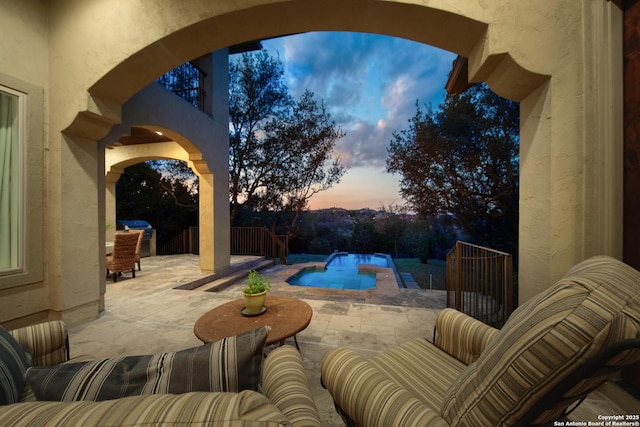 view of patio / terrace with fence and an outdoor pool