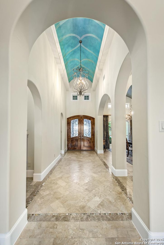 foyer with french doors, visible vents, baseboards, and an inviting chandelier