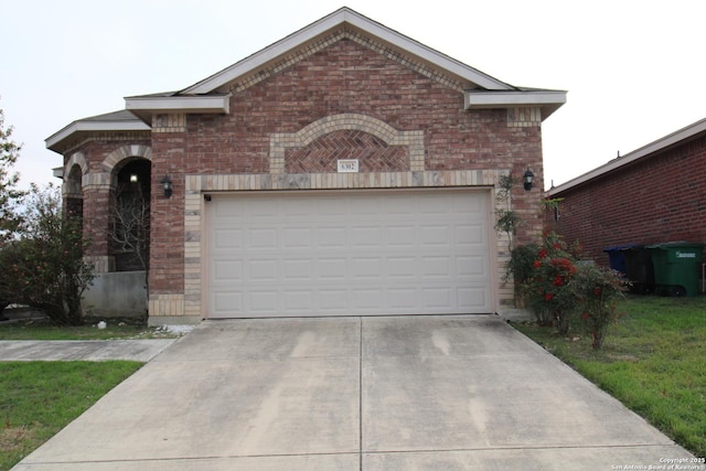 view of front of home featuring a garage, driveway, and brick siding